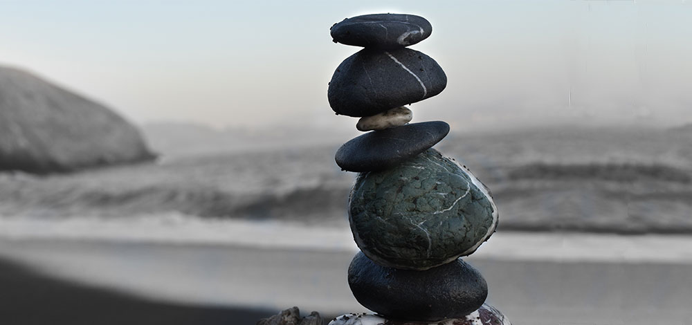 rock cairn at beach, stillness in motion